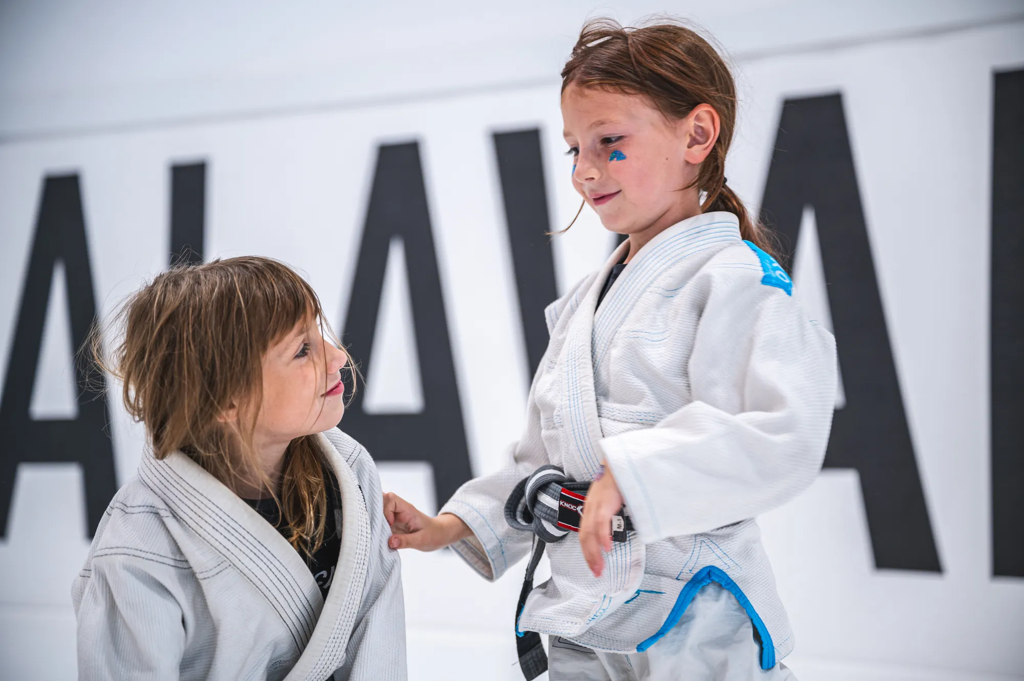 Two young children in Brazilian Jiu-Jitsu gis training together at ALAVANCA Shawnessy in Calgary